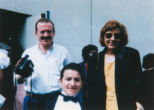 Parents and son at junior high school graduation