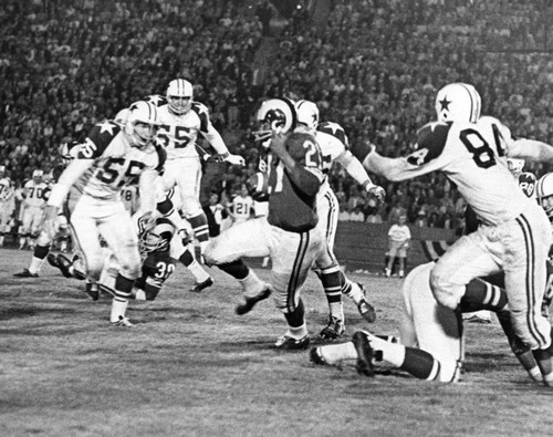 Pervis Atkins of the Rams is running, but four Cowboys are getting closer