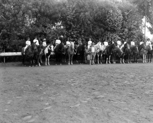 Unidentified young girls ride horseback