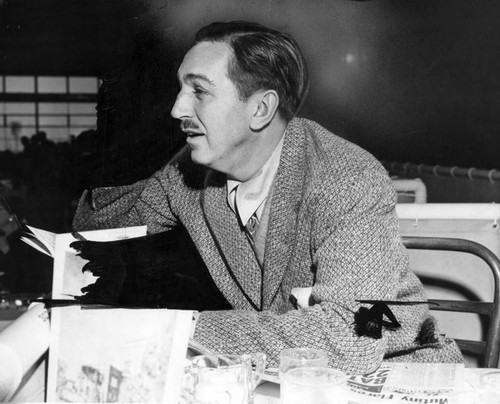 Walt Disney with a newspaper