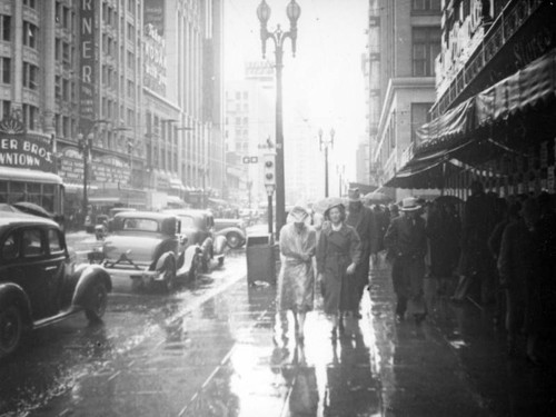 Walking in the rain by the Warner Downtown