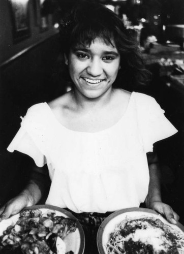 Woman holding plates of food