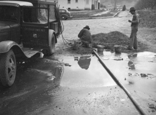 L.A. River flooding, Department of Water and Power workers in North Hollywood