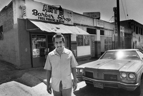 Arturo Benavidez in front of his barber shop