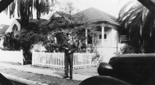 Chinese American soldier in front of house