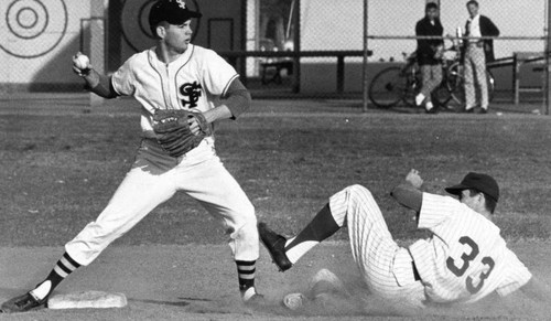 North Hollywood's John Koehler slides in, spikes high