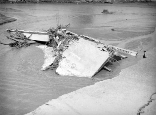 L.A. River flooding, twisted remains of the Lankershim Bridge