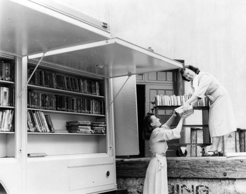 Replenishing the shelves of an LAPL Traveling Branch Bookmobile
