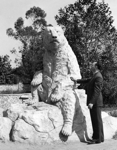 Man and statue of short-faced bear