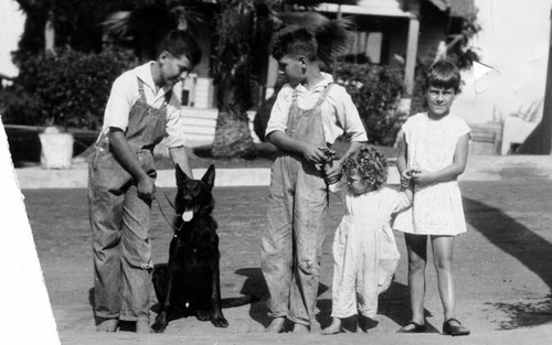 Children of Chief Davis holding police dog "Lobo"