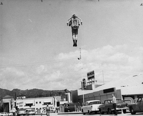 Bell Aerosystems engineer demonstrating rocket belt; man in the air