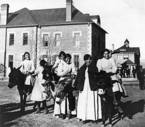 Women and burros at Santa Fe Indian School