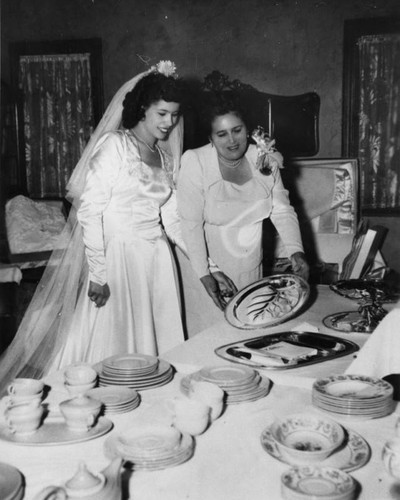 Bride and her mother with wedding gifts