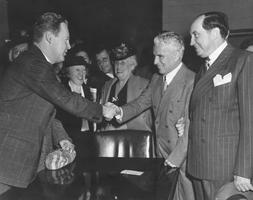 Charlie Chaplin shaking hands