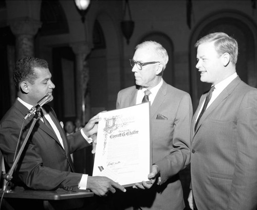 Billy Mills and Art Snyder present resolution to Dr. Everett B. Chaffee