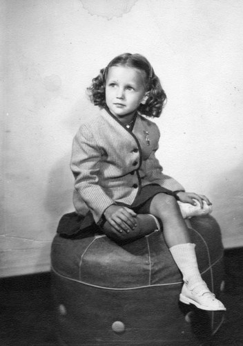 Girl posed on a hassock