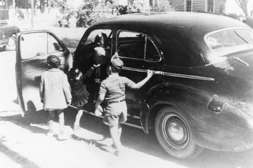 Children getting into automobile