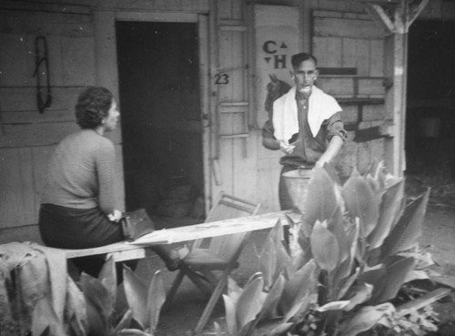 Man finishes shaving in front of stables at the Los Angeles County Fair