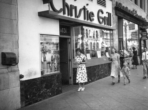 Pedestrians walk by Christie Grill