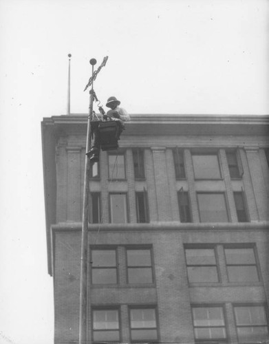 Man on flagpole