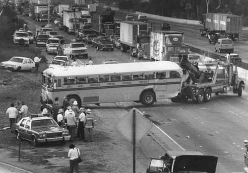 School bus hit on freeway by truck