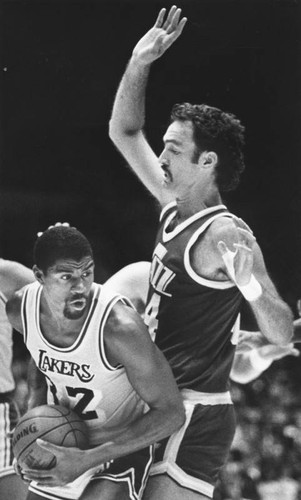 Magic Johnson playing hard against the Utah Jazz