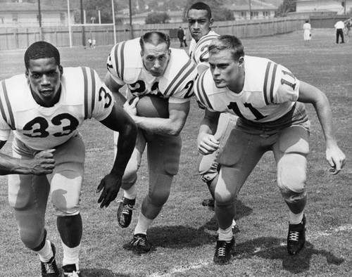 Quarterback Carl Jones hands off to Mike Dimkich [sic]