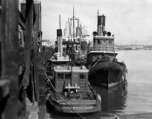 Tugboats tied up at harbor