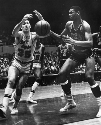 Lakers' Rudy LaRusso swats ball out of Ray Scott's hands at arena