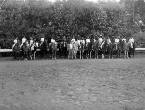 Unidentified young girls ride horseback