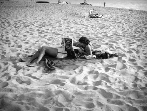 Sunbathing and reading Esquire at the beach