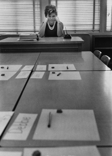 Teacher Doris Segall seated at desk