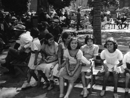 Children sitting on a park bench at the Plaza