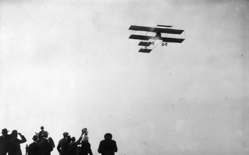 Mr. and Mrs. Paulhan in Farman biplane in flight