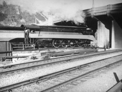 Train and workers under the Riverside Drive-Dayton Avenue Bridge