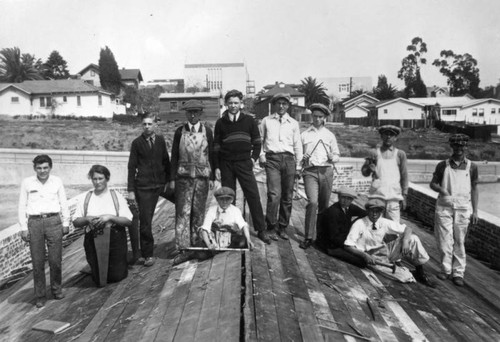 Young carpenter apprentices standing on a roof