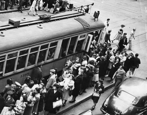 Commuters wait for electric trolley