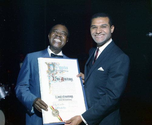 Louis Armstrong is presented with a resolution