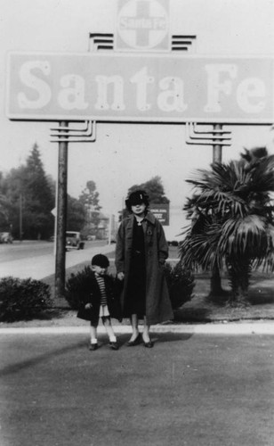 Mother and son at a train station