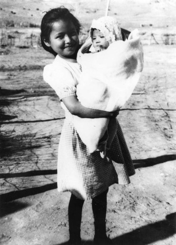 American Indian girl holding baby