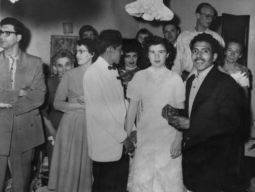 Mexican American groom with bride at celebration