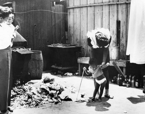 Mother with children in slum dwelling