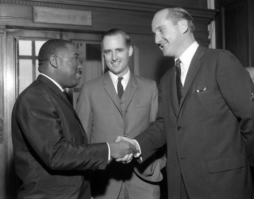 Congressional District Representative Thomas Rees shaking hands