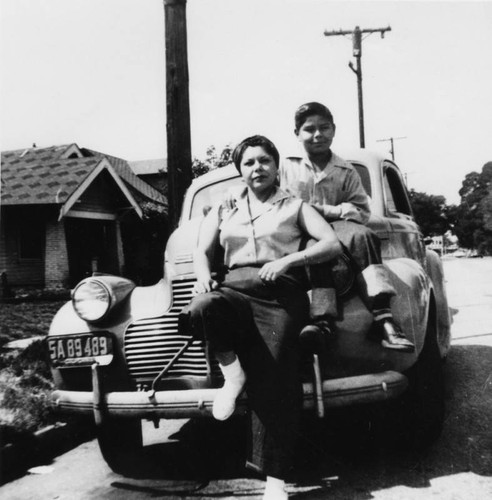 Mexican American woman and son on car