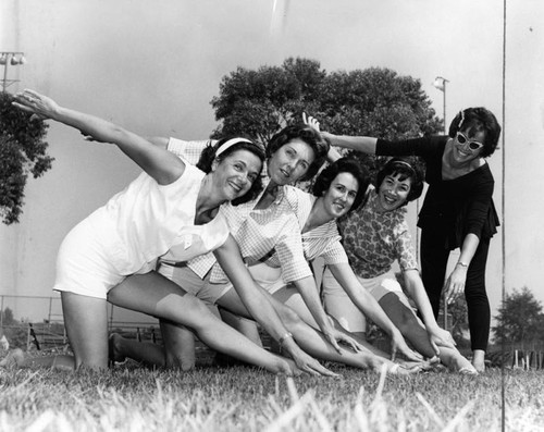 Women exercise at playground