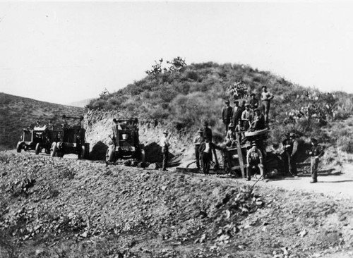 Overturned construction vehicle on mountain