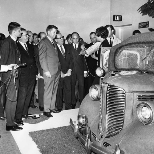 Clergy members examining Back Seat Dodge, 38