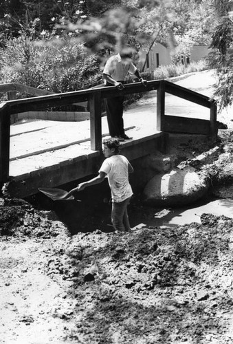 Youth corpsman shoveling mud