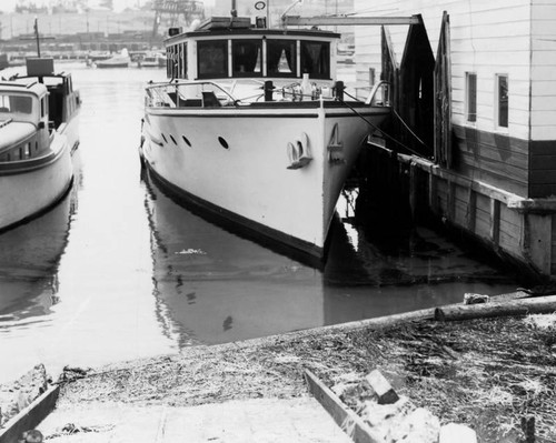 Boat anchored next to a building