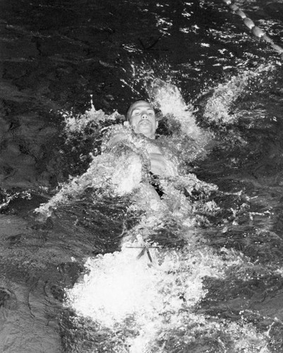 Ken Merten wins 100-meter backstroke